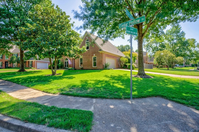 view of front of house with a garage and a front lawn