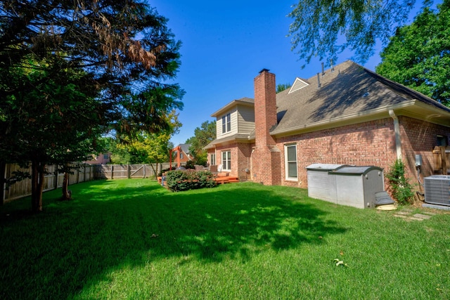 exterior space featuring a lawn and central AC