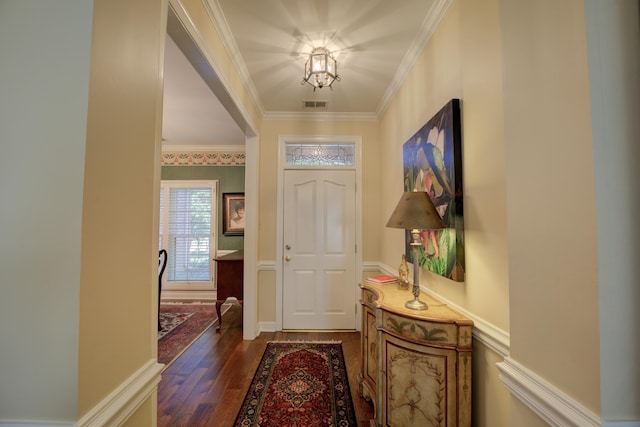 foyer entrance with ornamental molding and dark wood-type flooring