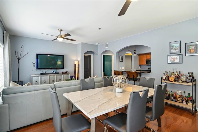 dining room featuring dark hardwood / wood-style floors and ceiling fan