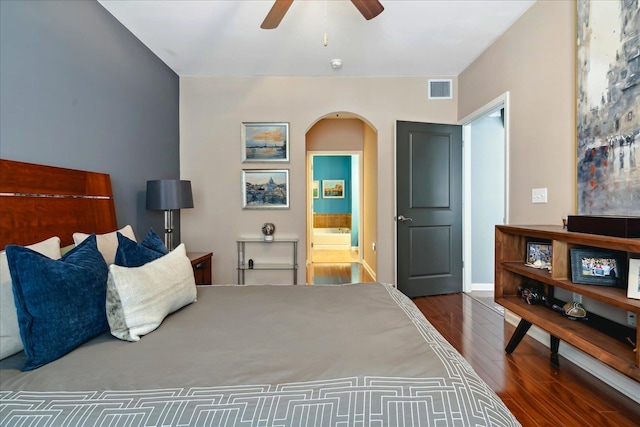 bedroom featuring ceiling fan, ensuite bathroom, and dark wood-type flooring