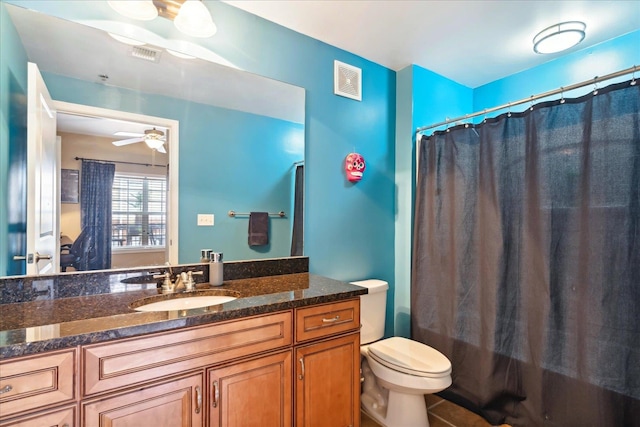 full bathroom featuring vanity, shower / bath combination with curtain, tile patterned flooring, ceiling fan, and toilet