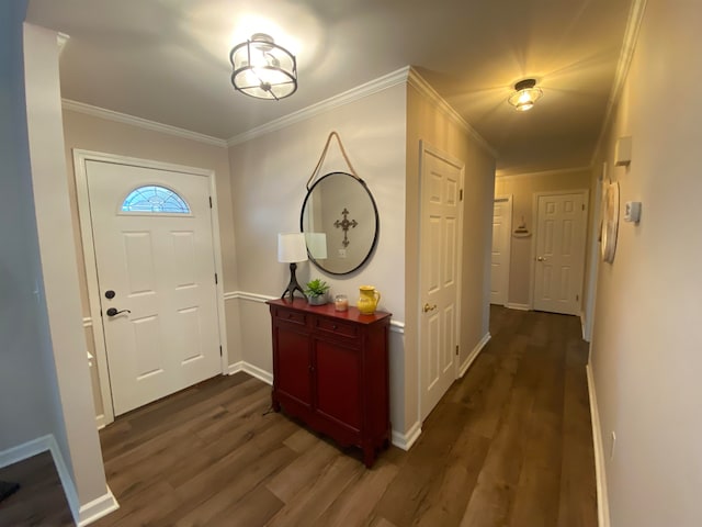 foyer with baseboards, ornamental molding, and dark wood-style flooring