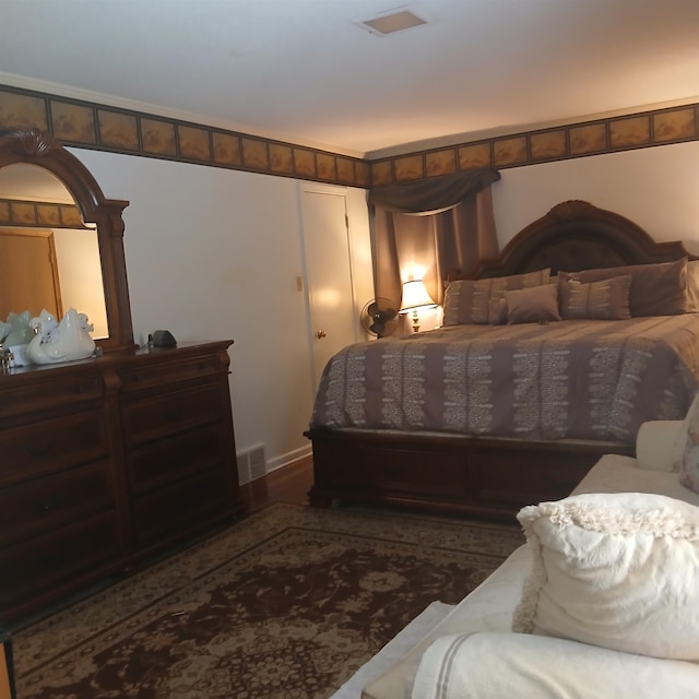 bedroom with dark wood-type flooring