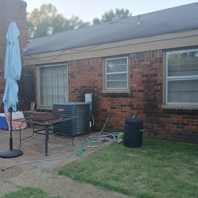 rear view of property with a patio and cooling unit