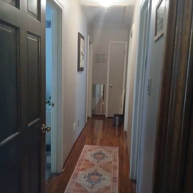 corridor with dark hardwood / wood-style floors