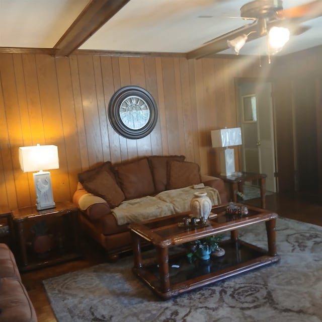 living room featuring wood walls, ceiling fan, beamed ceiling, and hardwood / wood-style flooring