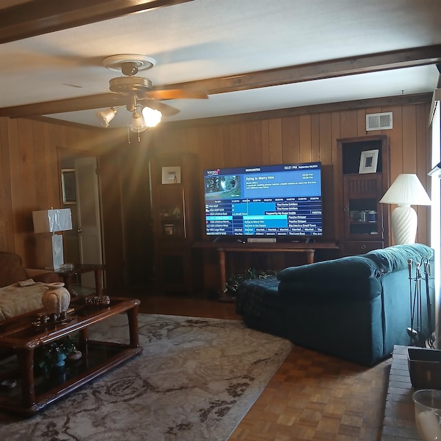 living room featuring ceiling fan, wooden walls, and parquet floors