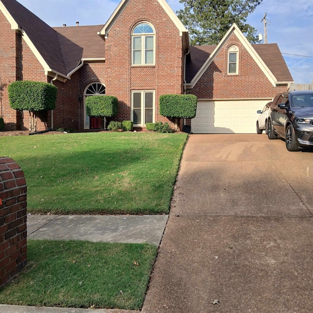 view of front of house with a garage and a front yard