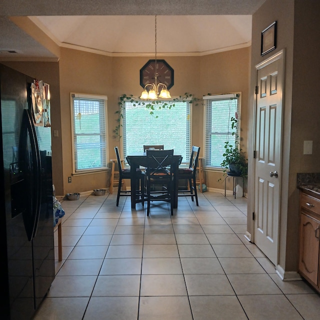 tiled dining area with a textured ceiling, crown molding, and a chandelier