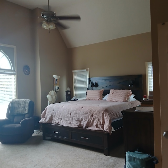 bedroom with ceiling fan, light carpet, and high vaulted ceiling