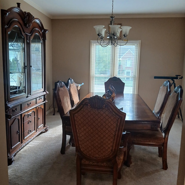 carpeted dining room featuring an inviting chandelier