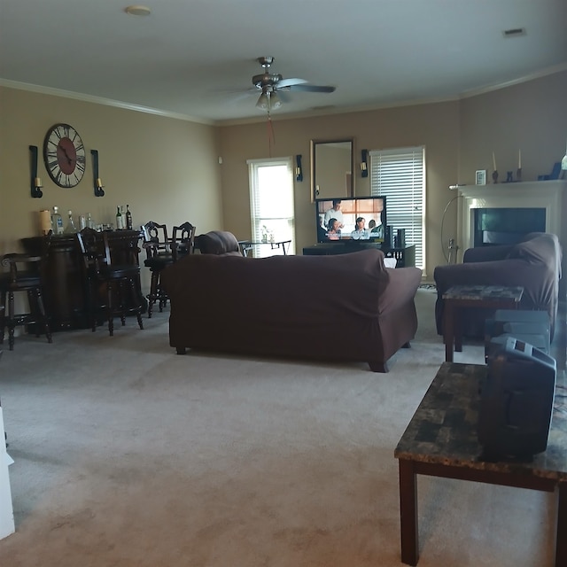 living room featuring ceiling fan, light carpet, and ornamental molding