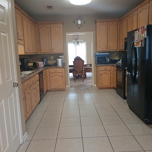 kitchen featuring black appliances, a chandelier, and light tile patterned floors