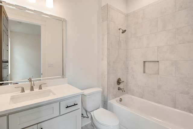 full bathroom with vanity, tiled shower / bath combo, and toilet