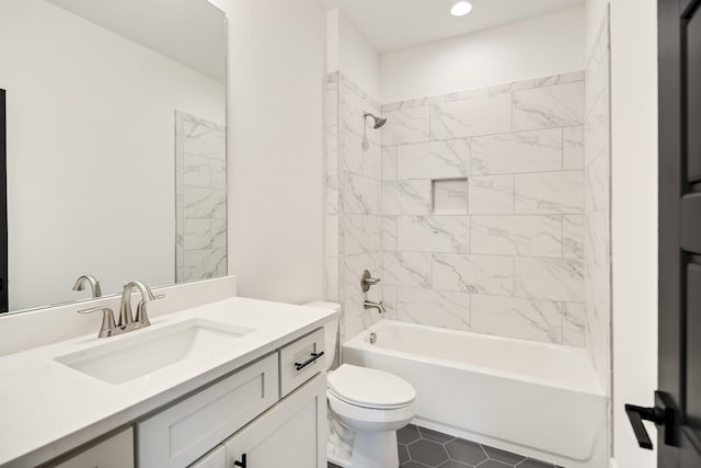 full bathroom with tiled shower / bath, vanity, toilet, and tile patterned floors