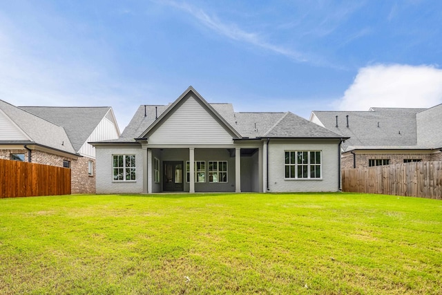 back of house featuring a lawn