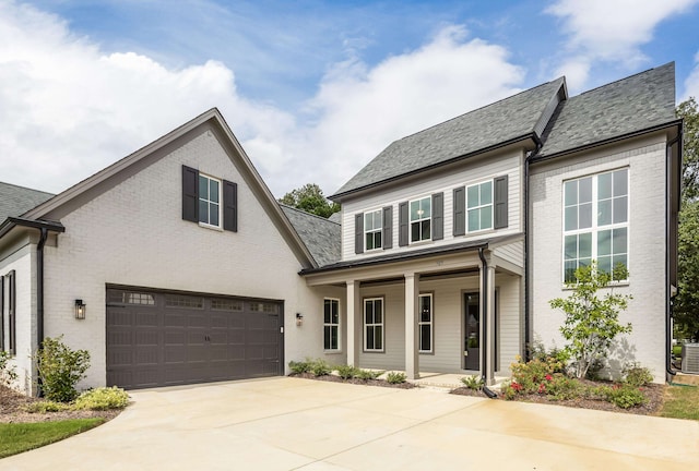 view of front of property featuring a porch, a garage, and central AC