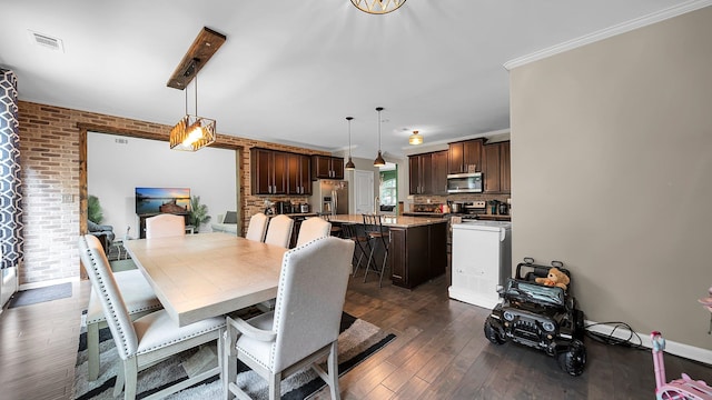 dining room featuring dark hardwood / wood-style flooring, ornamental molding, and brick wall