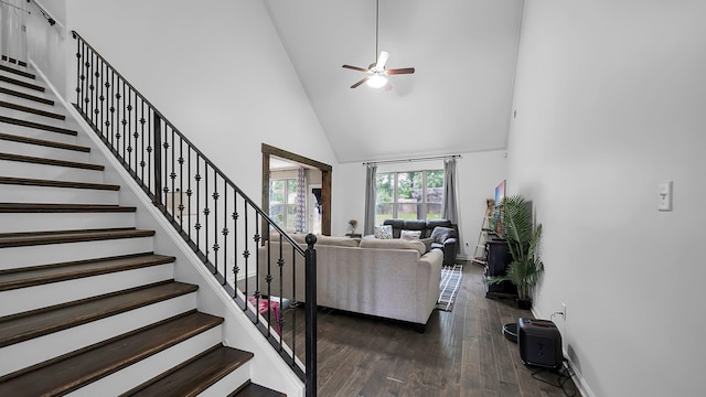 living room with high vaulted ceiling, ceiling fan, and dark wood-type flooring