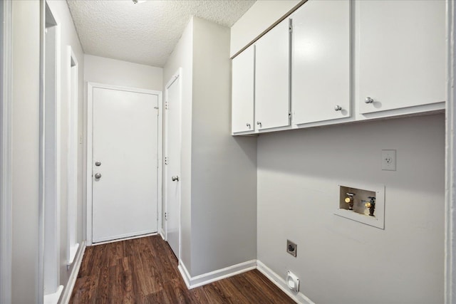 clothes washing area with hookup for a washing machine, hookup for an electric dryer, a textured ceiling, cabinets, and dark hardwood / wood-style floors