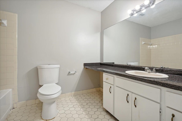 full bathroom with tile patterned floors, a textured ceiling, vanity, and toilet