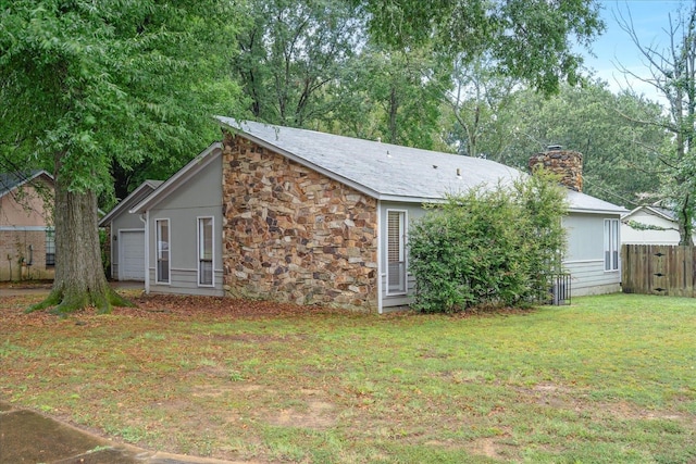 exterior space with a garage and a yard