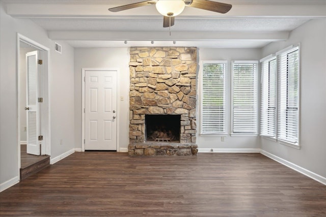 unfurnished living room with ceiling fan, dark hardwood / wood-style floors, a fireplace, and a textured ceiling