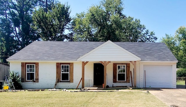 view of front facade with a garage, a front lawn, and covered porch