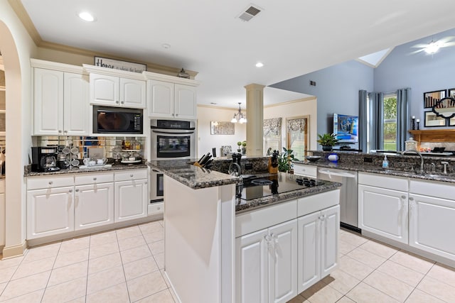 kitchen with dark stone counters, black appliances, white cabinetry, and light tile patterned floors