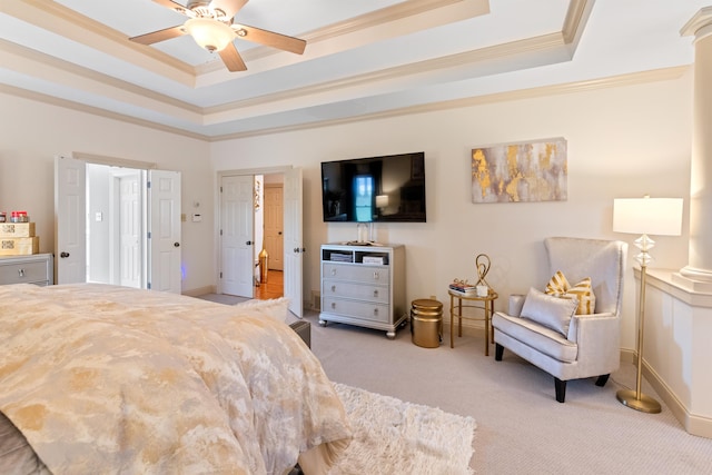 carpeted bedroom featuring ceiling fan, a tray ceiling, and crown molding