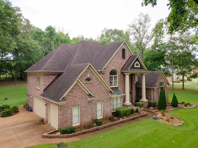 view of front facade with a garage and a front lawn