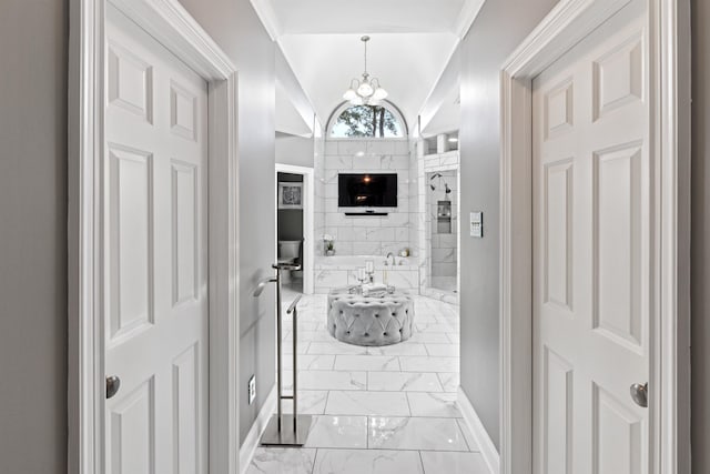 hallway with lofted ceiling and a chandelier