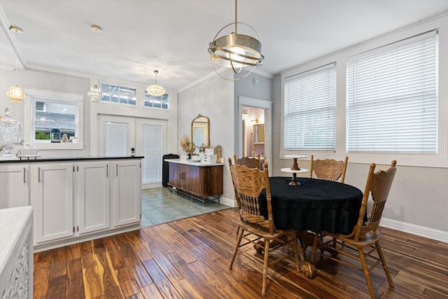 dining space featuring crown molding, a notable chandelier, and dark wood-type flooring