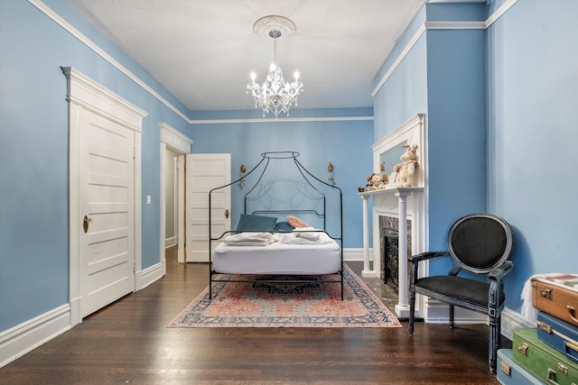 bedroom featuring dark wood-type flooring, crown molding, and an inviting chandelier