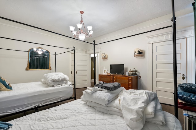 bedroom featuring a notable chandelier and hardwood / wood-style floors