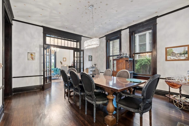 dining area with ornamental molding and dark hardwood / wood-style floors