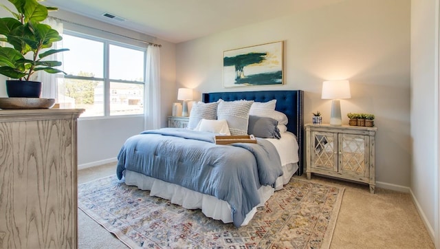 bedroom featuring light colored carpet