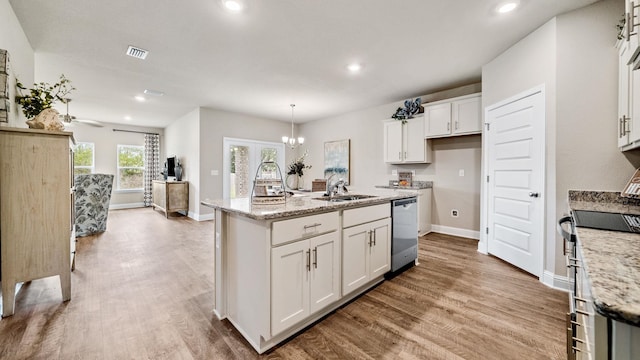 kitchen with hanging light fixtures, white cabinetry, light stone counters, a center island with sink, and stainless steel dishwasher