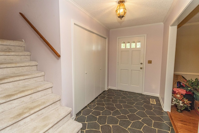 foyer with a textured ceiling, crown molding, and dark hardwood / wood-style flooring