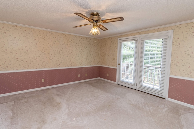 spare room with light carpet, a textured ceiling, ornamental molding, and ceiling fan