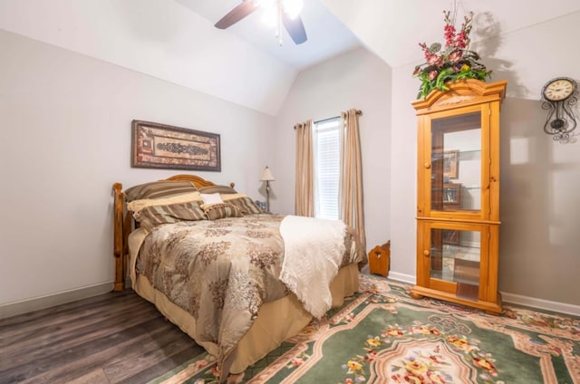 bedroom with ceiling fan, vaulted ceiling, and dark hardwood / wood-style flooring