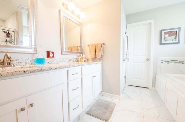 bathroom featuring a washtub and vanity