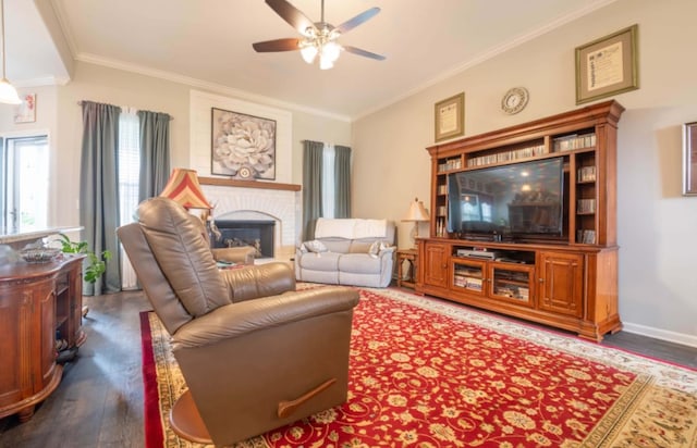 living room featuring ornamental molding, ceiling fan, a fireplace, and dark hardwood / wood-style flooring