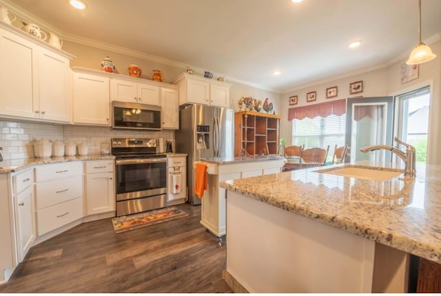 kitchen featuring white cabinetry, sink, pendant lighting, and stainless steel appliances