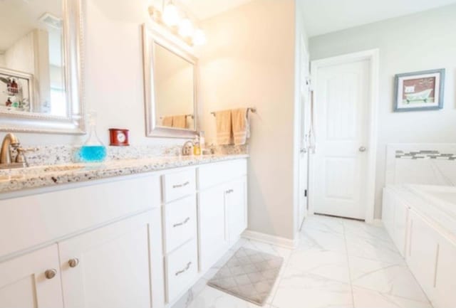 bathroom with vanity and a bathtub