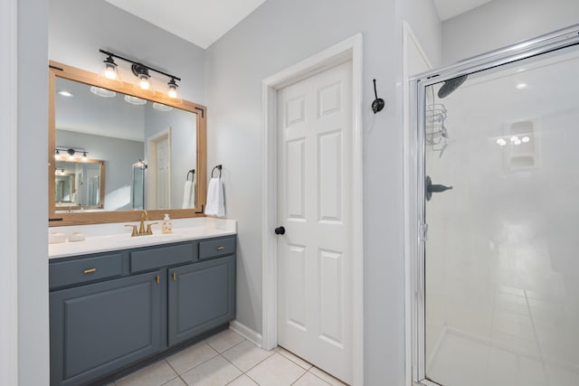 bathroom featuring vanity, a shower with shower door, and tile patterned floors