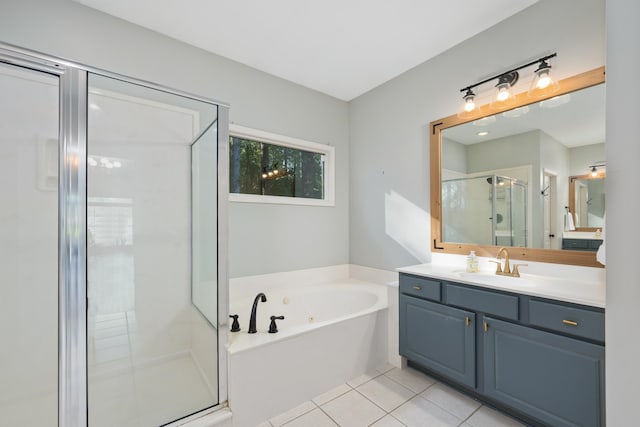 bathroom featuring independent shower and bath, vanity, and tile patterned flooring