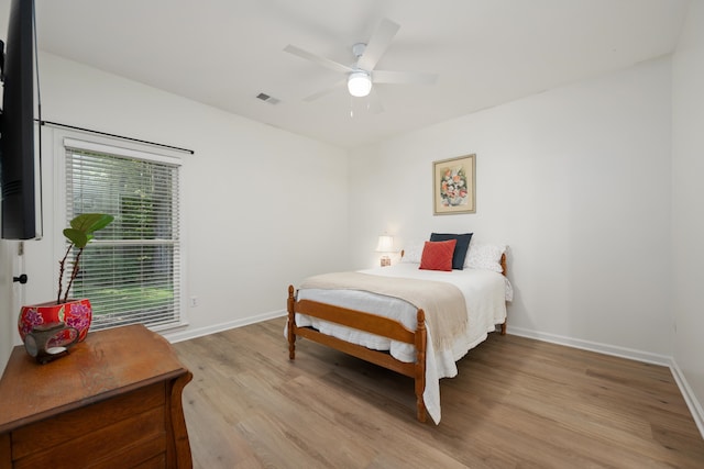 bedroom with light hardwood / wood-style floors and ceiling fan