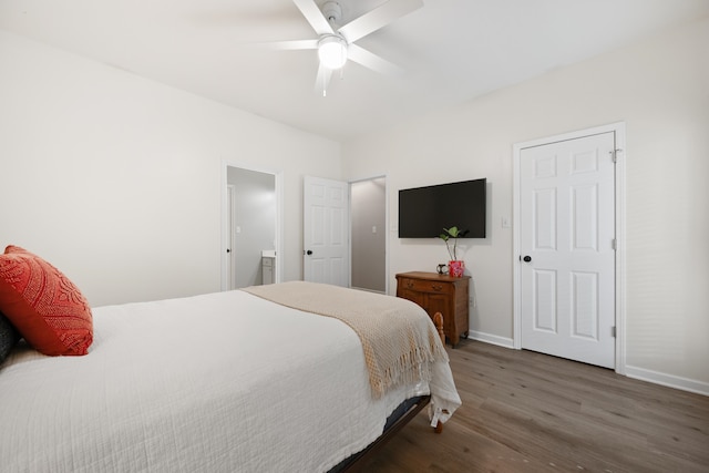 bedroom featuring ceiling fan, connected bathroom, and dark hardwood / wood-style floors